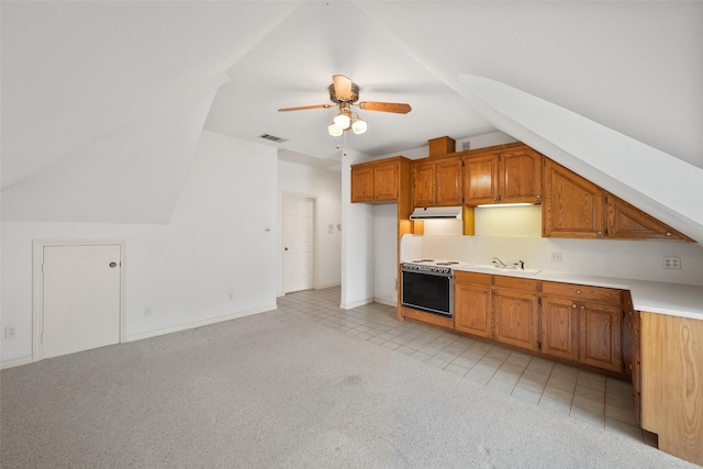 kitchen featuring lofted ceiling, light carpet, sink, range with electric cooktop, and ceiling fan