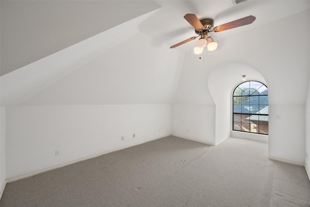 bonus room featuring ceiling fan, light colored carpet, and vaulted ceiling