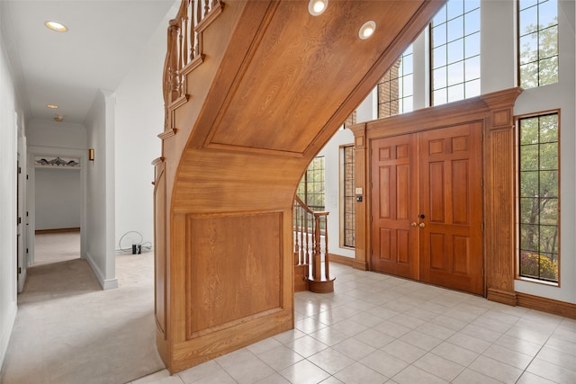 carpeted entrance foyer with a healthy amount of sunlight