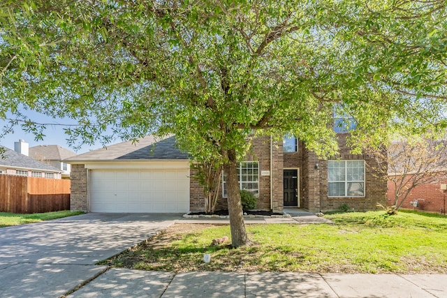 view of front of property with a front yard and a garage