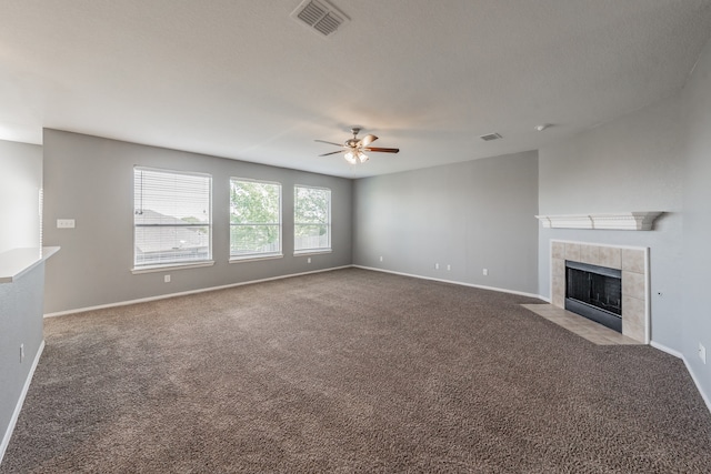 unfurnished living room with carpet, a fireplace, and ceiling fan