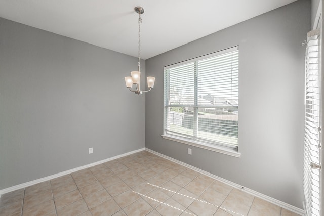 spare room featuring a chandelier and light tile patterned floors