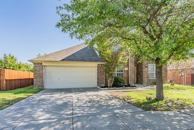 view of front of home featuring a front yard and a garage