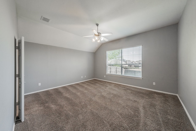 carpeted empty room featuring ceiling fan and vaulted ceiling