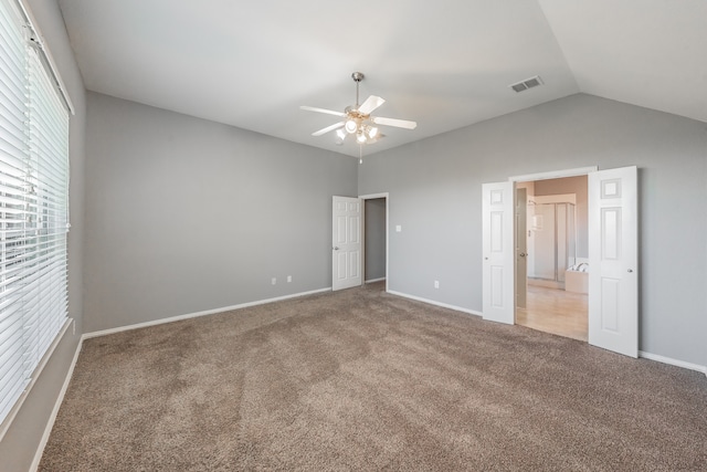 unfurnished bedroom featuring ceiling fan, carpet flooring, and vaulted ceiling