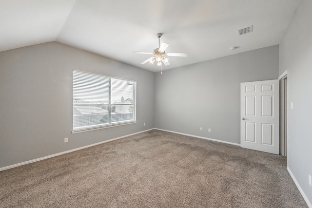 empty room with vaulted ceiling, carpet flooring, and ceiling fan