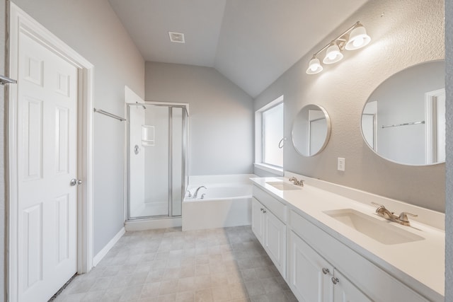 bathroom featuring vanity, independent shower and bath, and lofted ceiling