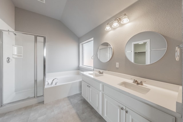 bathroom with vanity, vaulted ceiling, and shower with separate bathtub