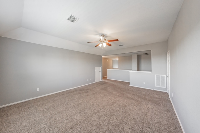 carpeted empty room featuring vaulted ceiling and ceiling fan