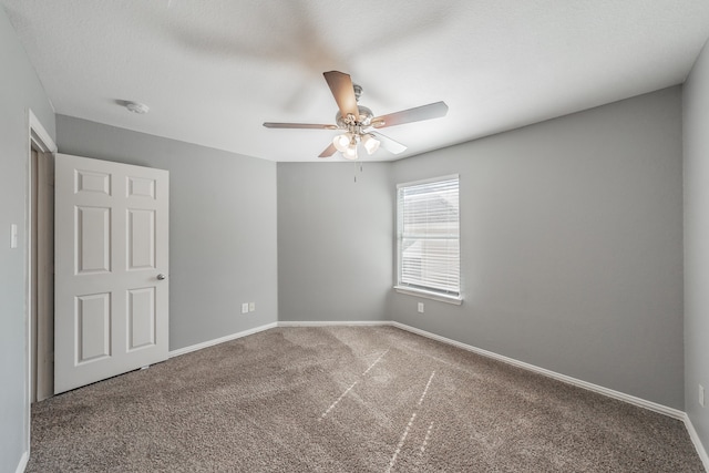 spare room featuring a textured ceiling, carpet flooring, and ceiling fan