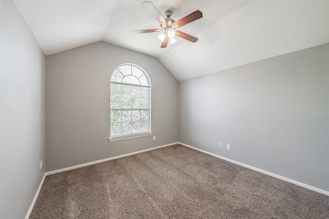 carpeted spare room featuring lofted ceiling and ceiling fan