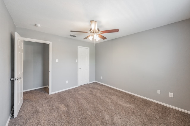 unfurnished bedroom featuring ceiling fan and carpet floors