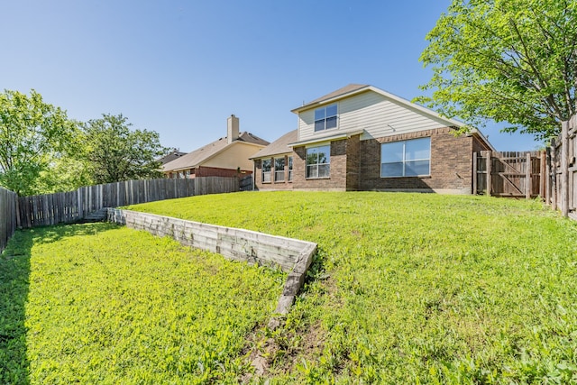 rear view of house with a lawn