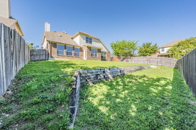 rear view of house with a lawn