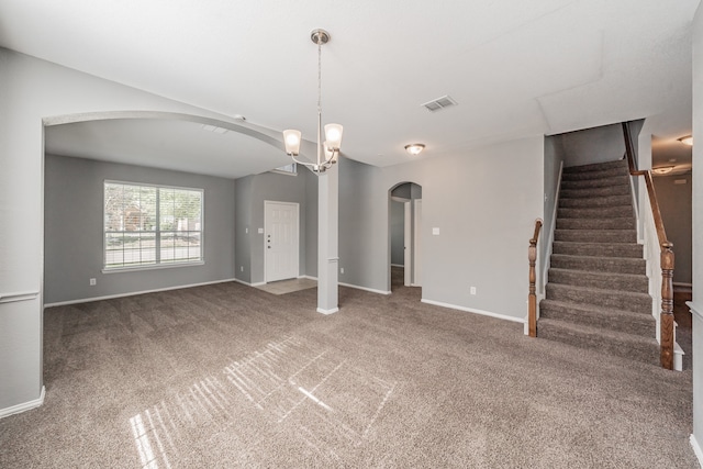 unfurnished living room with carpet and a chandelier