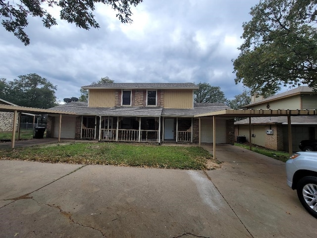 view of front of house featuring covered porch, a garage, and a carport