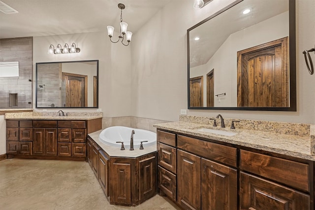 bathroom featuring vanity, a notable chandelier, concrete flooring, and a bathtub