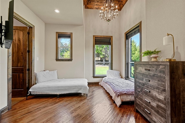 living area featuring a notable chandelier and hardwood / wood-style flooring