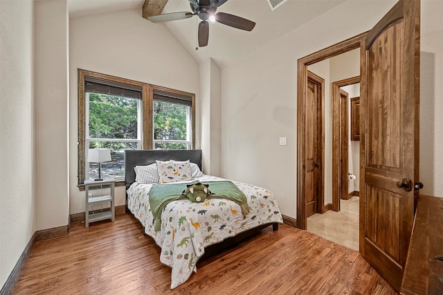 bedroom with ceiling fan, lofted ceiling with beams, and hardwood / wood-style floors