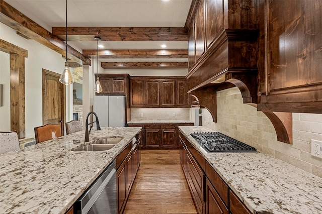 kitchen featuring sink, appliances with stainless steel finishes, light hardwood / wood-style flooring, and backsplash