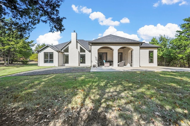 back of house with a yard and a patio area