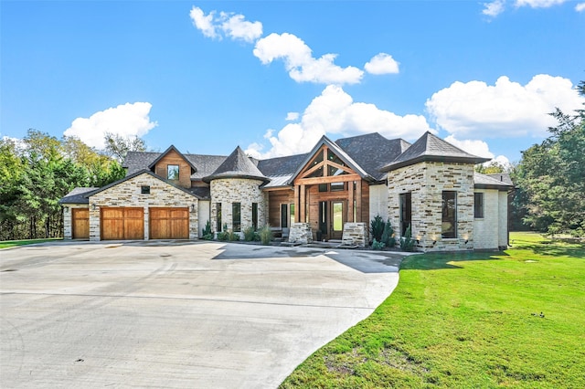 french country style house featuring a front lawn and a garage