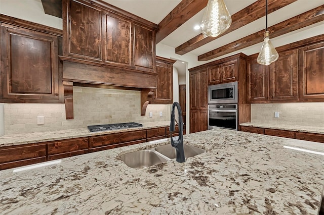 kitchen with beamed ceiling, dark brown cabinets, sink, decorative light fixtures, and appliances with stainless steel finishes