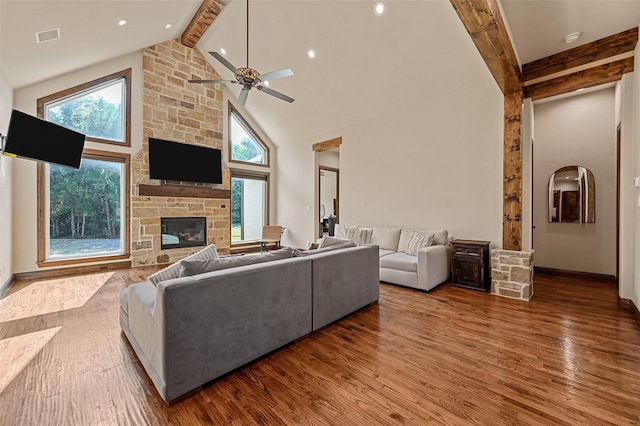 living room with hardwood / wood-style floors, high vaulted ceiling, and a healthy amount of sunlight