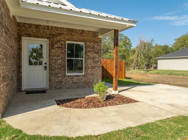 property entrance featuring a patio area