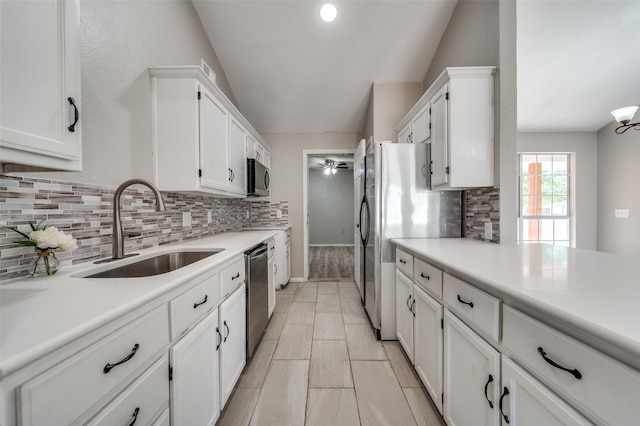 kitchen featuring white cabinets, tasteful backsplash, stainless steel appliances, and sink