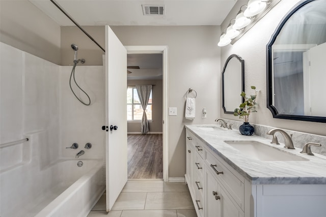 bathroom featuring vanity, washtub / shower combination, and tile patterned floors