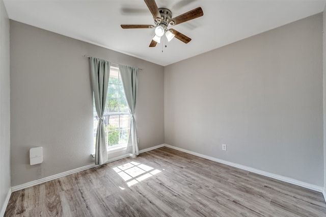 spare room featuring light hardwood / wood-style floors and ceiling fan