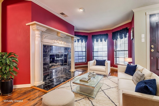 living room with hardwood / wood-style floors and crown molding