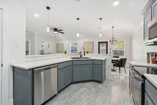 kitchen with appliances with stainless steel finishes, gray cabinets, a wealth of natural light, and sink