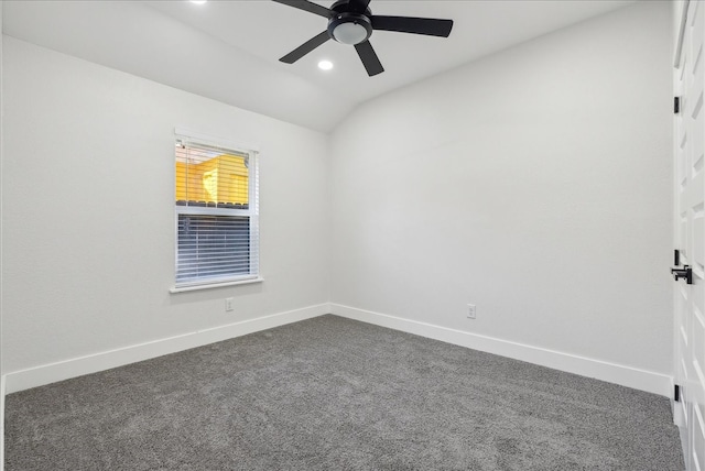 carpeted empty room with ceiling fan and lofted ceiling