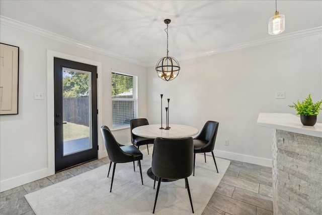 dining area with a chandelier, light wood-type flooring, and ornamental molding