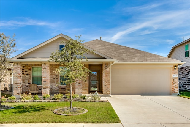 view of front of home featuring a front yard and a garage