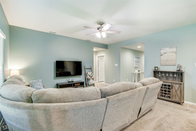 living room featuring ceiling fan and light colored carpet