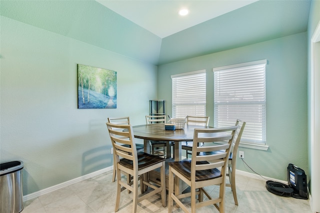 dining area featuring lofted ceiling