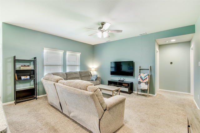 living room with light carpet and ceiling fan