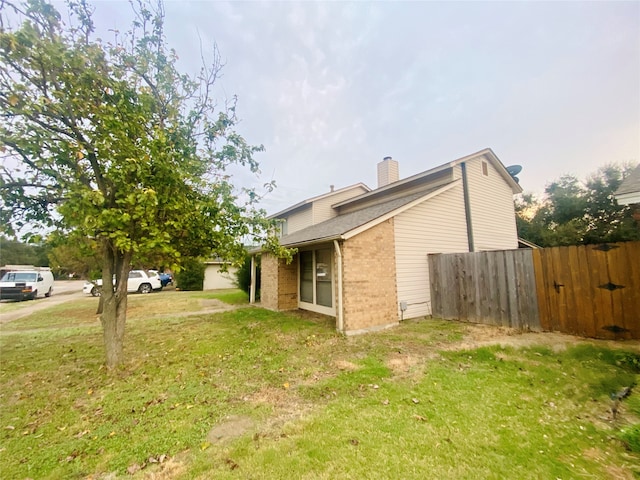 view of side of home featuring a yard