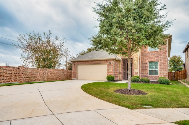 view of front of home with a front yard and a garage