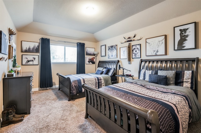 bedroom with lofted ceiling and light colored carpet