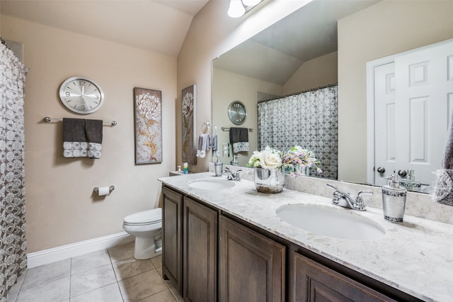 bathroom featuring vanity, toilet, tile patterned floors, and vaulted ceiling