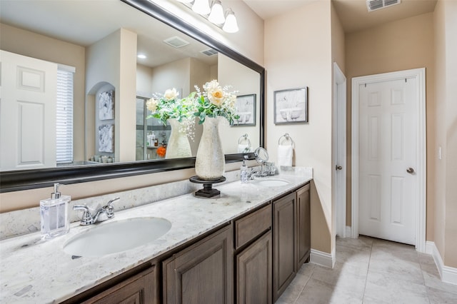 bathroom featuring vanity, tile patterned floors, and a shower with shower door