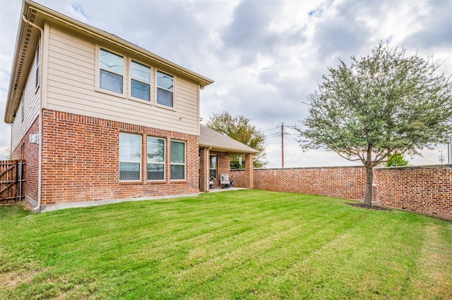 rear view of house with a lawn