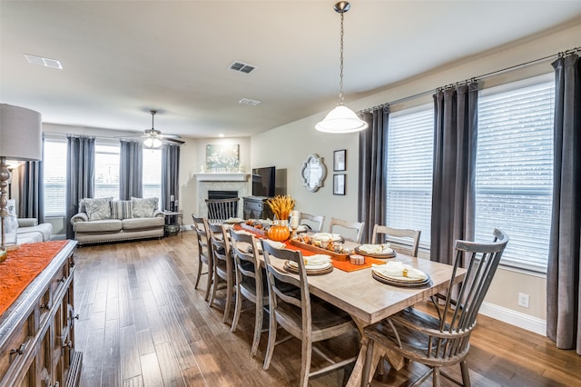 dining space featuring ceiling fan and dark hardwood / wood-style flooring