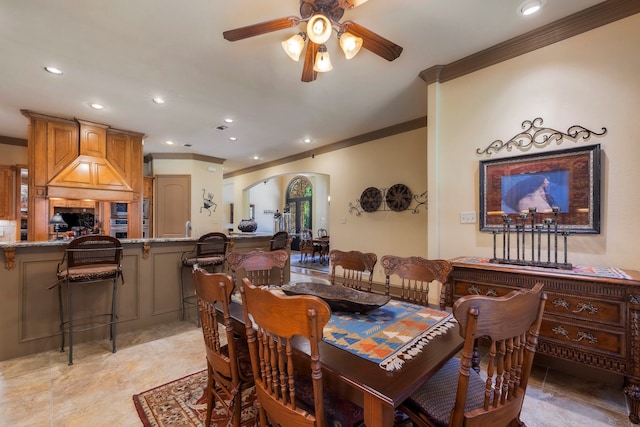 dining area with ceiling fan and ornamental molding