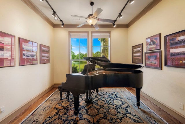 misc room with ornamental molding, ceiling fan, wood-type flooring, and rail lighting