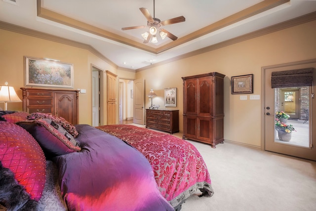 carpeted bedroom featuring ornamental molding, a tray ceiling, and ceiling fan